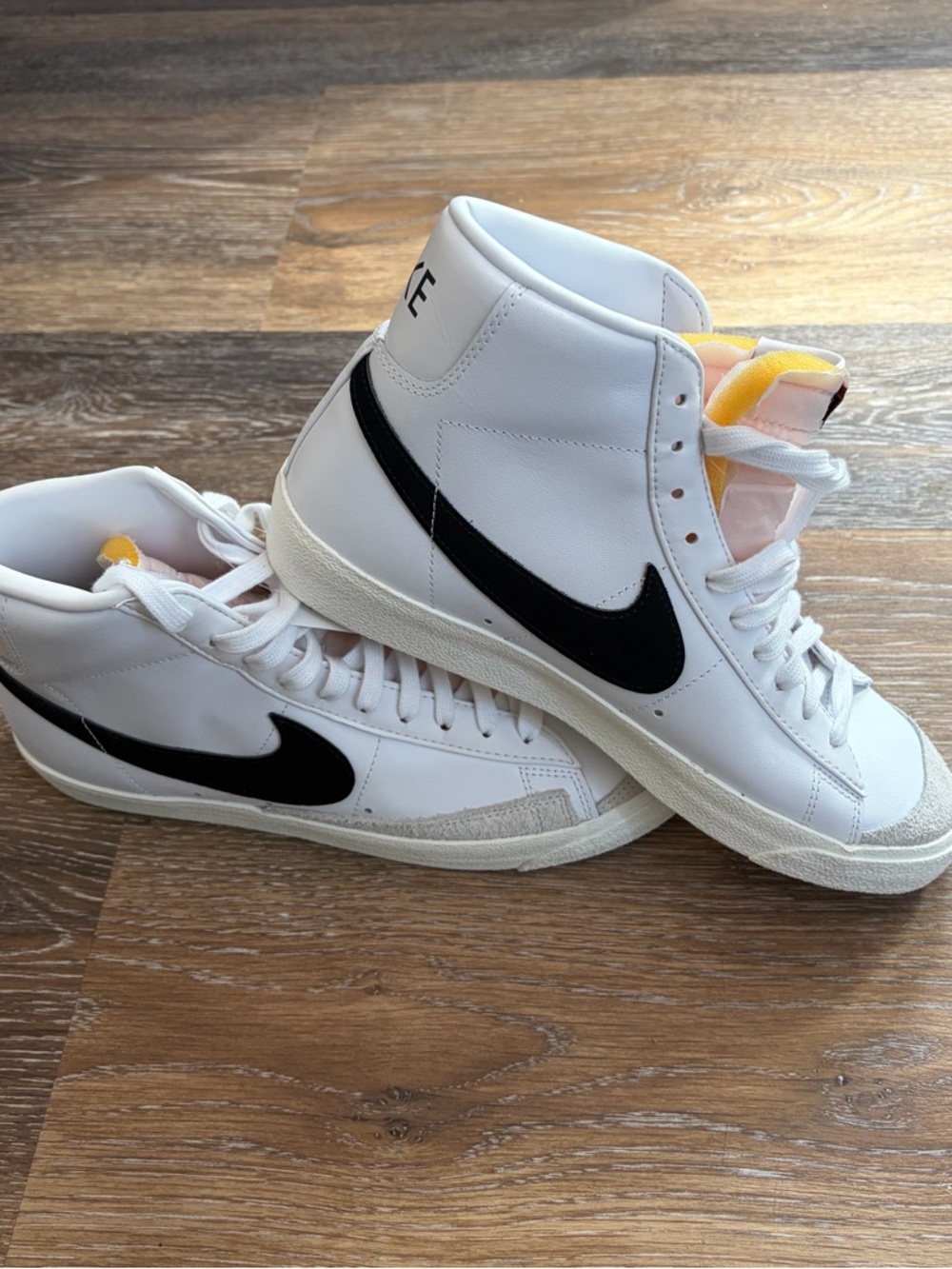 Nike White High-Top Sneakers with Black Swoosh and Yellow Tongue